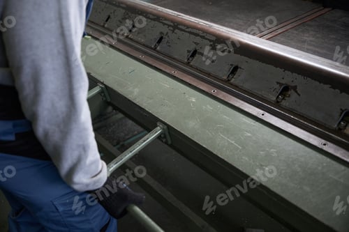 Preview: Worker forms a bend of aluminum profile on special machine