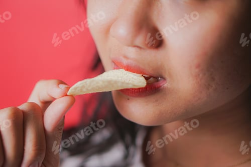 Preview: woman eating crispy potato chip