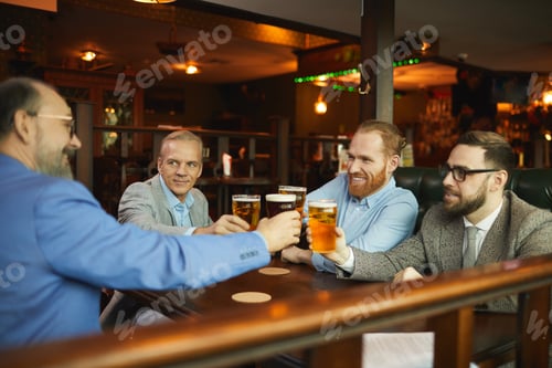 Preview: Colleagues drinking beer in cafe