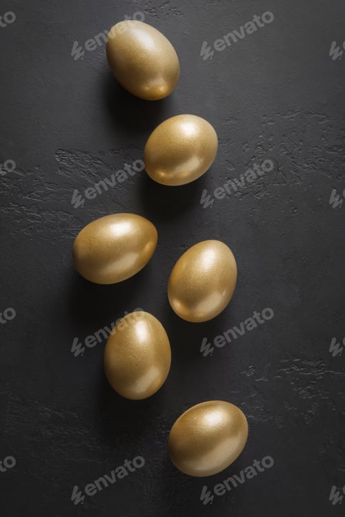 Preview: Chicken golden eggs on black. Easter dark concept. View from above.