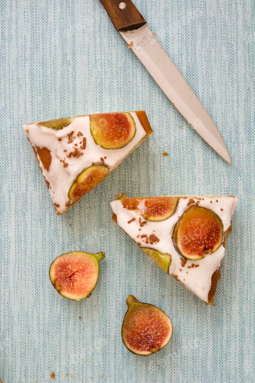 Preview: Slices of delicious homemade fig cake with cream cheese frosting decorated with chocolate sprinkles