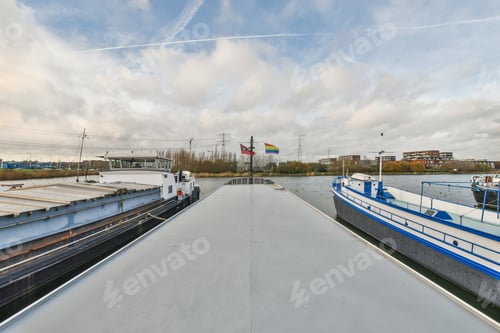 Preview: Long barge with flags on river
