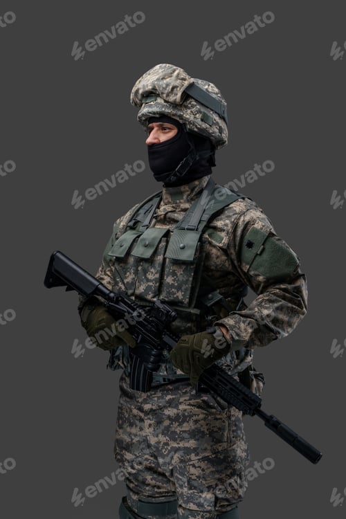 Preview: Proud soldier with rifle isolated on grey background