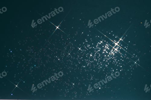 Preview: Abstract deep blue background with sparkles in the shape of stars.