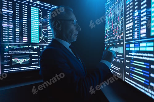 Preview: The businessman stands near the big digital screen in the dark office