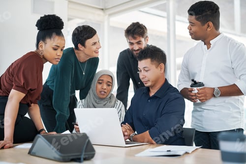Preview: Shot of a group of businesspeople using a laptop during a meeting in a modern office