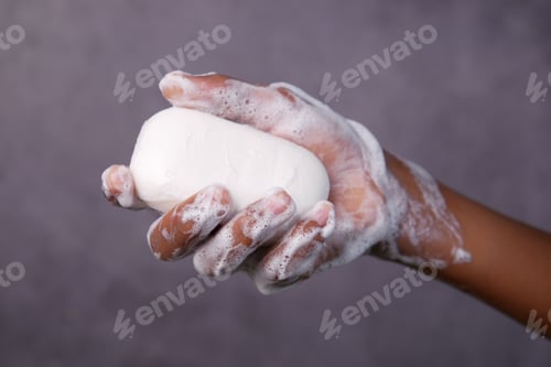 Preview: young man washing hands with soap warm water