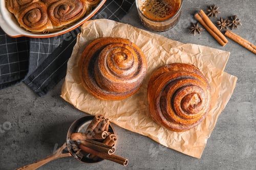 Preview: Flat lay composition with freshly baked cinnamon rolls on grey background