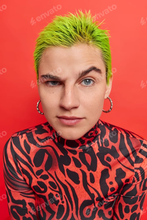 Preview: Photo of calm serious hipster girl with bright green hairstyle raises eyebrows listens attentively i