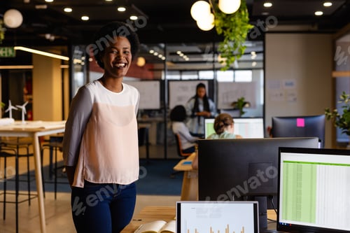Preview: Portrait of happy african american casual businesswoman with afro in office