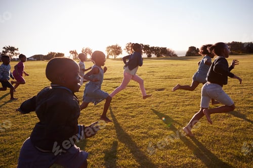 Preview: Elementary school boys and girls running in an open field