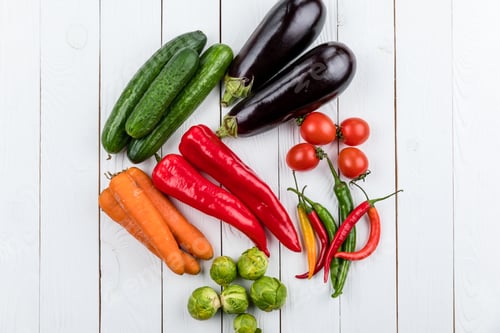 Preview: different fresh seasonal vegetables on white wooden table background