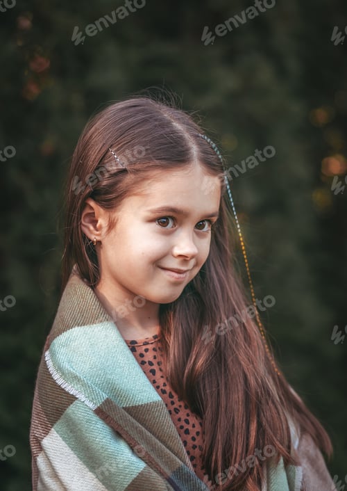 Preview: Portrait of a young beautiful brunette little girl outdoor in summer day.