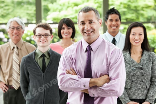 Preview: A portrait of a mixed race team of business people with a Caucasian businessman in the lead.