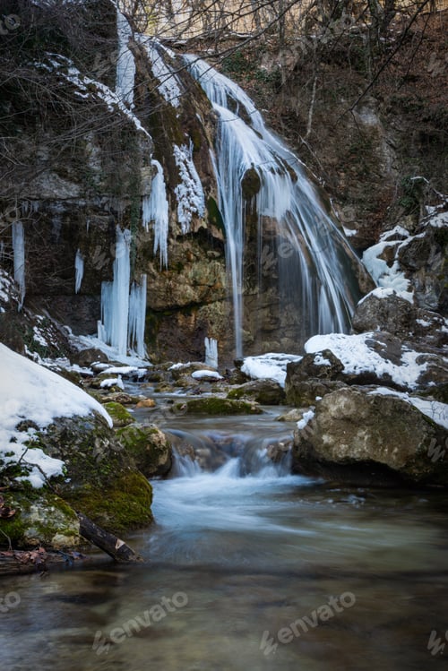 Preview: Frozen waterfall with icicles. Winter hike to the waterfall Jur-Jur in the Crimea.