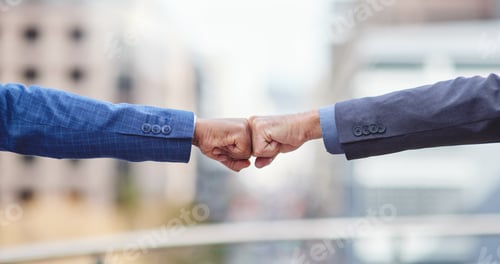 Preview: Cropped shot of two unrecognizable businessmen fist bumping outside