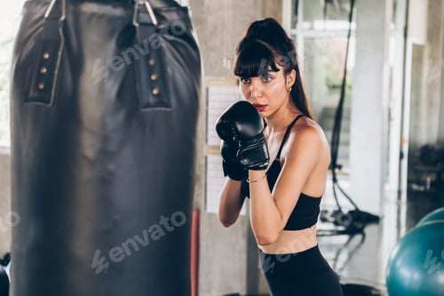 Preview: Female boxer punching bag