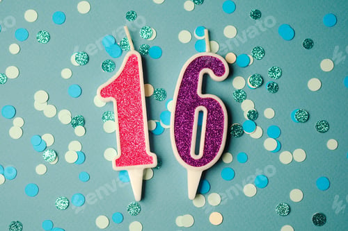 Preview: Colorful birthday candles on a table with blue and green confetti