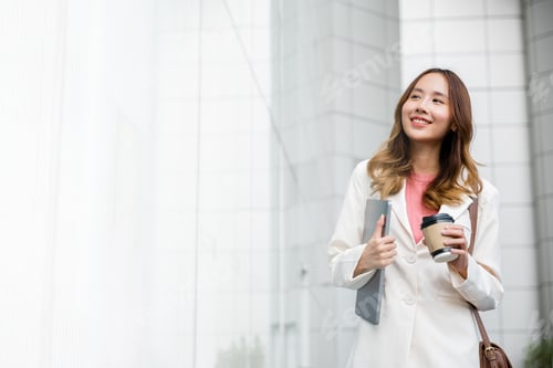 Smiling Woman Walking with Laptop and Coffee