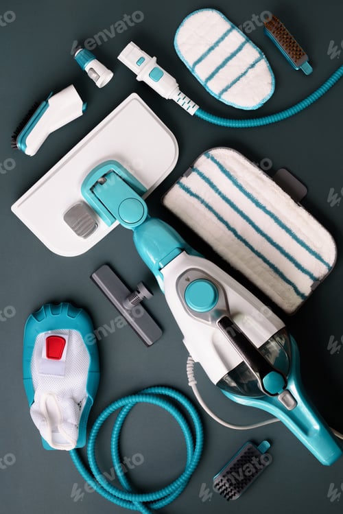 Preview: Set with modern professional steam cleaners on grey background. Top view, flat lay. Banner with copy