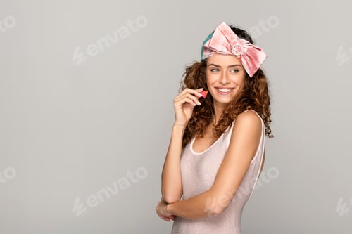 Preview: Smiling Woman with Curly Hair and Pink Bow
