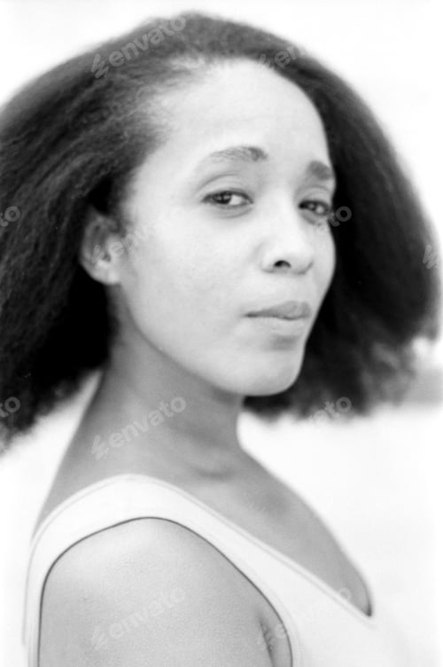 Preview: Black and white analog portrait of confident woman with afro hair