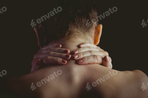 Preview: Nude woman with a neck injury on black background