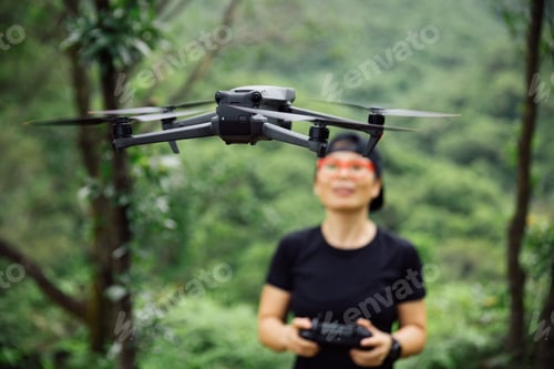 Preview: People remote control a flying drone in summer forest