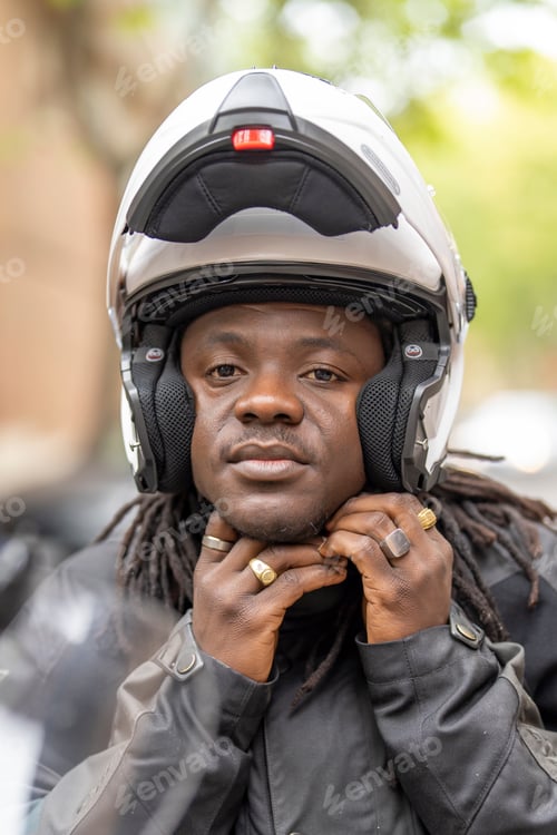 Preview: Man on motorcycle fastening safety helmet