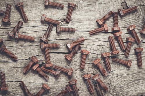 Preview: rusty screw bolt on the wooden table