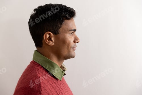 Preview: Happy biracial man with black hair over white wall at home