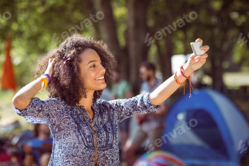 Preview: Pretty hipster taking a selfie at a music festival