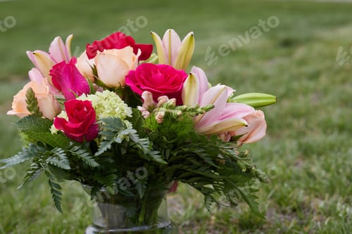 Preview: Close-up photo of a bunch of fresh flowers in the vase at the Garden