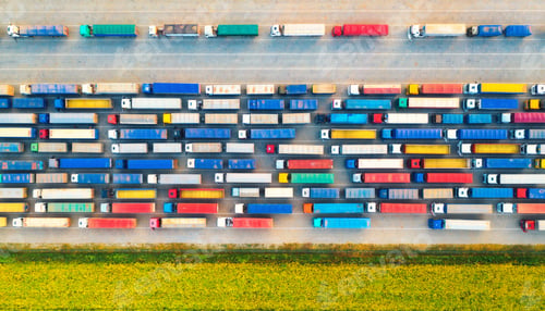 Preview: Aerial view of colorful trucks in terminal at sunset in summer