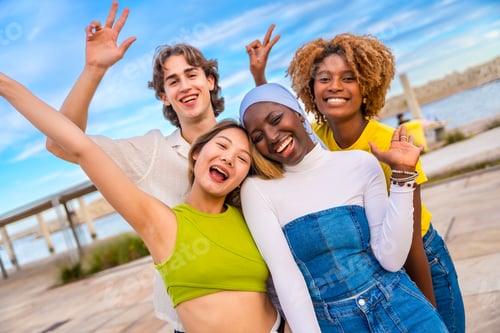 Preview: Multi-ethnic friends gesturing peace in an urban space