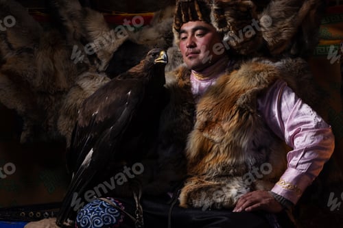 Preview: A Mongolian eagle hunter poses proudly inside a traditional gear