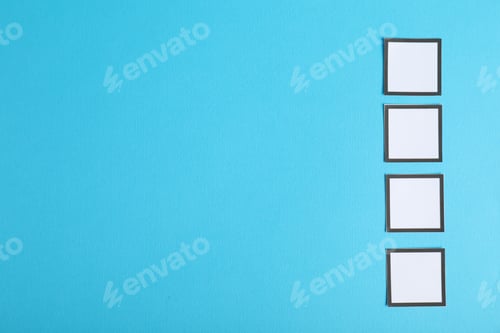 Preview: Empty checkboxes on light blue background, flat lay. Space for text