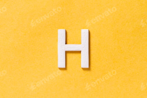Preview: Letter H of the alphabet isolated on yellow background, top view