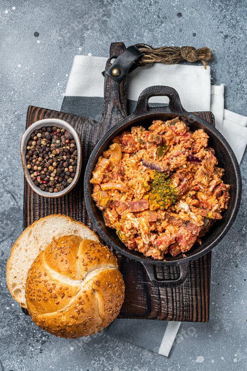 Preview: Turkish breakfast with Menemen omelet and bread. Dark background. Top view