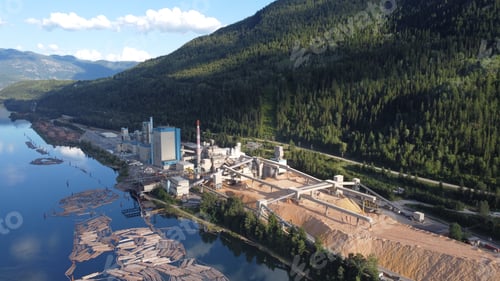Preview: Aerial view of the factory of pulp production near the hills on the river in Castlegar