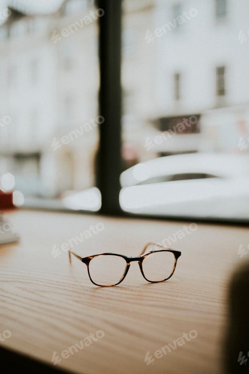 Preview: Pair of glasses on a wooden table