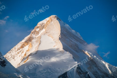 Preview: Majestic mountain peak with sunlight and shadows