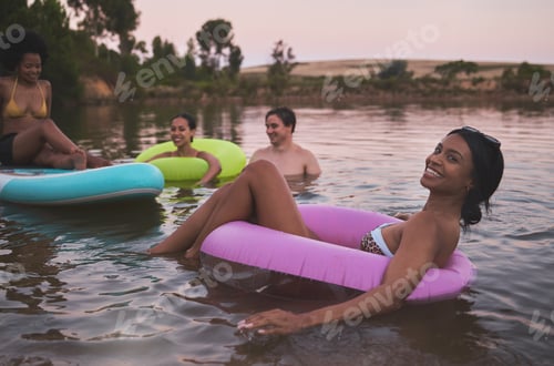 Preview: Vacation, swimming and diverse friendship having fun in a lake while enjoying summer. Happy friends