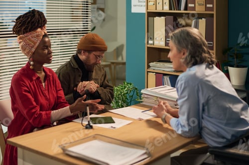 Preview: Consulting Middle Aged Social Worker Assisting Diverse Young Adult Couple
