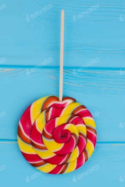 Preview: Colorful spiral lollipop candy on stick.