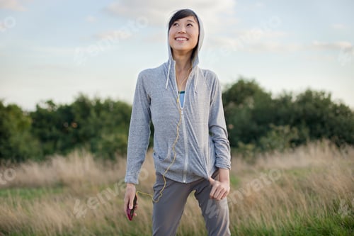 Preview: Portrait of young female runner with MP3 player