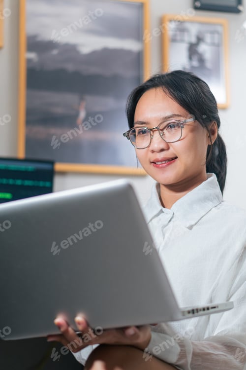 Preview: Young Woman Coding in Modern Office
