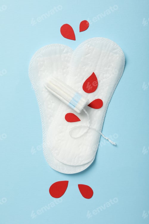 Preview: Tampons and pads for menstrual days on a blue background