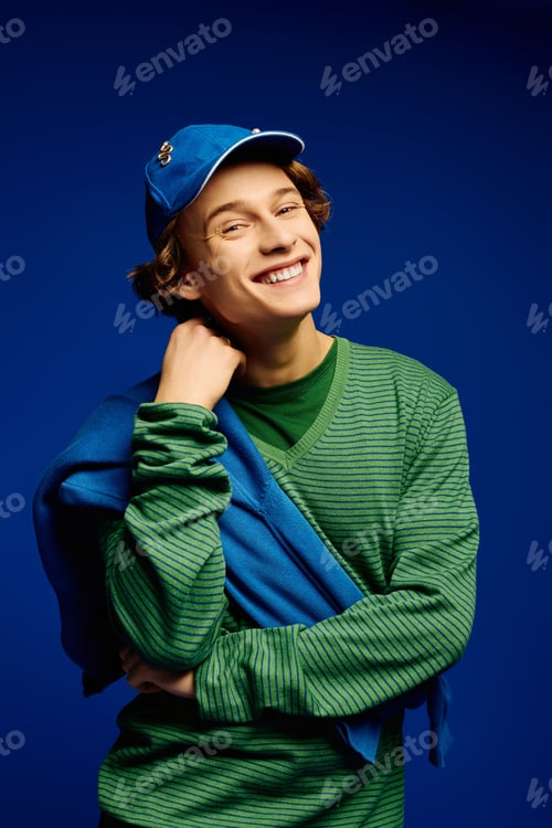 Preview: Fashionable young man showcases modern style against a vibrant backdrop capturing youth culture