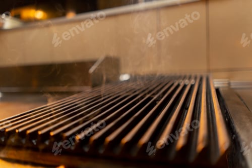Preview: close-up of a hot grill in the kitchen restaurant equipment for cooking